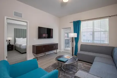 a living room with a couch and a tv at New Modern Vista Cay Reserve Condo - 6006 in Orlando