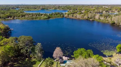 an aerial view of a large lake with trees at Lakefront Retreat - Boat - Fish - Close to all Orlando Parks - Disney - Universal - SeaWorld in Orlando