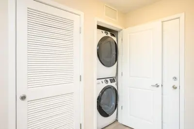 a laundry room with two washer and dryer at New Modern Vista Cay Reserve Condo - 6007 in Orlando