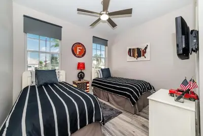 a bedroom with two beds and a ceiling fan at Special Offer Beautiful Pvt Pool home in Kissimmee