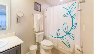 a bathroom with a toilet and a shower curtain at Special Offer Cozy Retreat at Compass Bay in Kissimmee