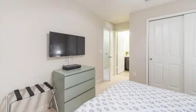 a bedroom with a bed and a tv on a wall at Special Offer Cozy Retreat at Compass Bay in Kissimmee
