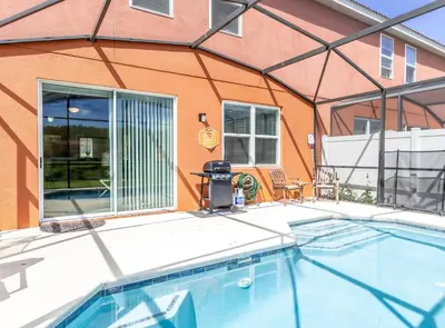 a swimming pool in front of a house at Special Offer Fantastic Townhome with Pvt Pool and Lake view near Disney in Kissimmee