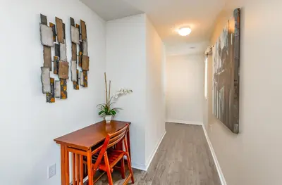 a hallway with a desk and paintings on the wall at Special Offer Fantastic Townhome with Pvt Pool and Lake view near Disney in Kissimmee