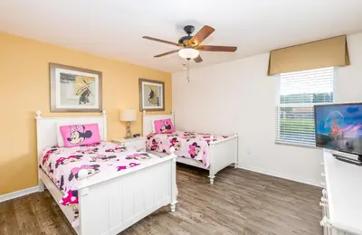 a bedroom with two beds and a ceiling fan at Special Offer Fantastic Townhome with Pvt Pool and Lake view near Disney in Kissimmee