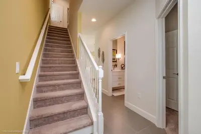a staircase in a home with white walls and carpet at Special Offer Luxury Retreat with Pool in Orlando