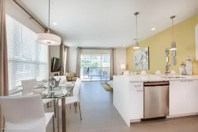 a kitchen and dining room with a table and chairs at Special Offer Luxury Retreat with Pool in Orlando