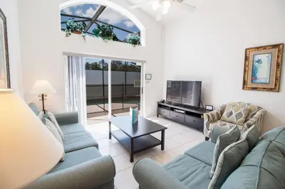 a living room with two couches and a tv at Special Offer Private Pool Home at Seasons Community in Kissimmee