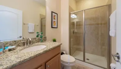 a bathroom with a shower and a sink and a toilet at Special Offer Pvt Pool Townhome in Kissimmee