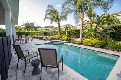 a patio with chairs and a swimming pool at Special Offer Pvt Pool and Spa Home at Encore in Orlando