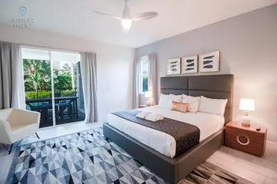 a bedroom with a large bed and a balcony at Special Offer Pvt Pool and Spa Home at Encore in Orlando
