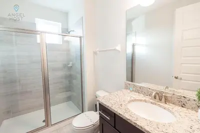 a bathroom with a shower and a sink and a toilet at Special Offer Pvt Pool and Spa Home at Encore in Orlando