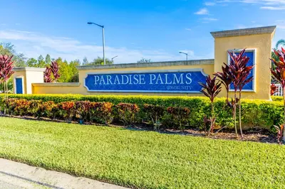 a building with a sign that reads paradise palms at Special Offer Stunning TownHome With Private Pool close to Disney 8960PP in Kissimmee
