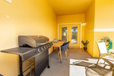 a kitchen with a grill and a table with chairs at Special Offer Stunning TownHome With Private Pool close to Disney 8960PP in Kissimmee