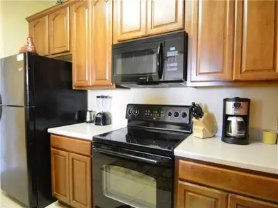 a kitchen with a black stove and a microwave at Special Offer Stylish Apartment at Vista Cay Resort in Orlando