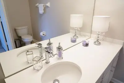 a bathroom with a sink with two lamps on it at New Luxury Disney Townhome at Windsor Hills Resort, 3BED 3BATH, Private Pool Parking WiFi Included in Orlando