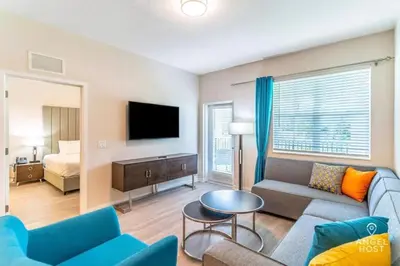 a living room with a couch and a tv and a bed at Special Offer Stylish Apartment at Vista Cay in Orlando