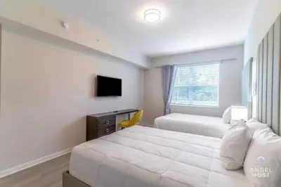 a hotel room with two beds and a television at Special Offer Stylish Apartment at Vista Cay in Orlando