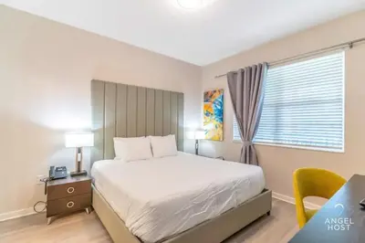 a bedroom with a bed and a desk and a window at Special Offer Stylish Apartment at Vista Cay in Orlando