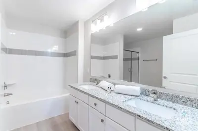 a bathroom with two sinks and a large mirror at Special Offer Stylish Apartment at Vista Cay in Orlando