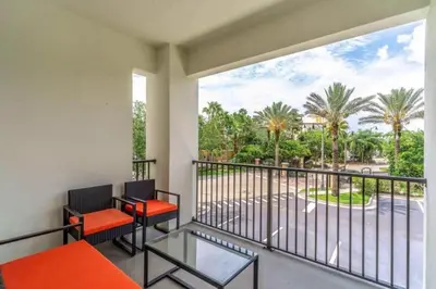 a balcony with two chairs and a view of a street at Stylish Apartment at Vista Cay in Orlando