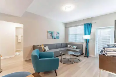 a living room with a couch and a table at Stylish Apartment at Vista Cay in Orlando