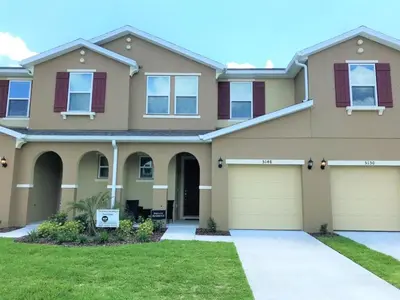 a large house with a garage at Special Offer Townhome at Compass Bay in Kissimmee