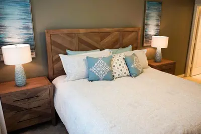 a bedroom with a bed with pillows and two lamps at Special Offer Townhome at Compass Bay in Kissimmee