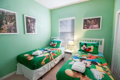 two beds in a room with green walls at Special Offer Townhome at Oakwater Resort in Orlando