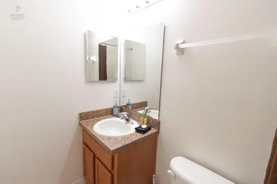 a bathroom with a sink and a mirror at Special Offer Townhome at Oakwater Resort in Orlando