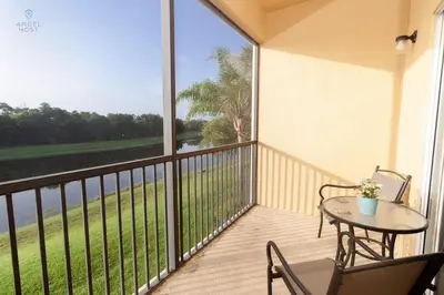 a balcony with a table and chairs and a view of the ocean at Special Offer Townhome at Oakwater Resort in Orlando