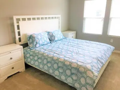a bedroom with a bed with a blue comforter at TVPM5150CHCB in Kissimmee