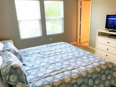 a bedroom with a bed and a television in it at TVPM5150CHCB in Kissimmee