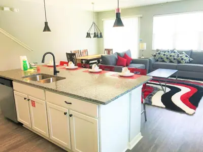 a kitchen and living room with a sink and a couch at TVPM5150CHCB in Kissimmee