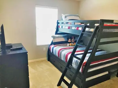 a bedroom with a bunk bed with two dolls on it at TVPM5150CHCB in Kissimmee