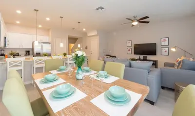 a dining room and living room with a table and chairs at TVPM5164ADCB in Kissimmee