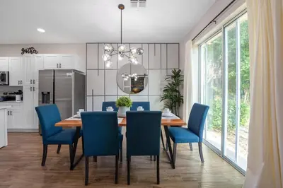 a dining room with a table and blue chairs at New Listing - Modern decoration 4 BR Townhouse in Kissimmee