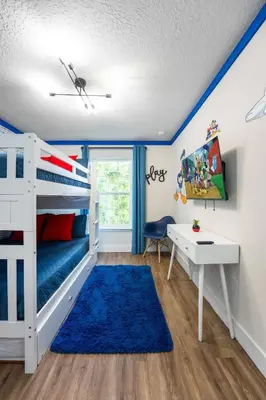 a bedroom with a white bunk bed and a desk at New Listing - Modern decoration 4 BR Townhouse in Kissimmee