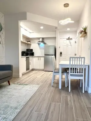 a kitchen and dining room with a table and chairs at Condo close to Epic Universe - free parking in Orlando