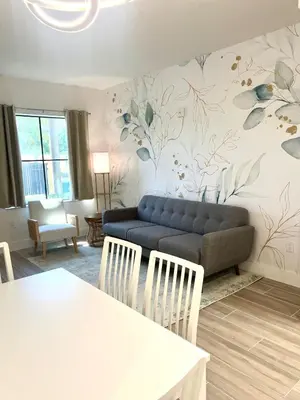 a living room with a couch and a table at Condo close to Epic Universe - free parking in Orlando