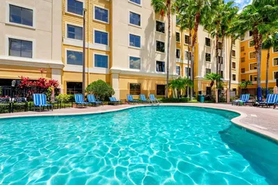 a swimming pool in front of a building at Condo close to Epic Universe - free parking in Orlando
