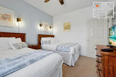 a bedroom with two beds and a tv in it at Charming Oasis with King Bed Close to Disney 4BR in Kissimmee