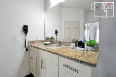 a bathroom with a sink and a mirror at Charming Oasis with King Bed Close to Disney 4BR in Kissimmee