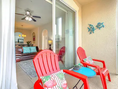 a living room with two red chairs and a table at Windsor Hills Amazing 3BR Condo,Pool,Slides,Disney in Orlando