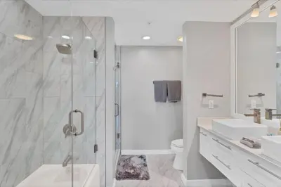 a bathroom with a shower and a toilet and a sink at Modern 3 bedroom condo in downtown w free parking in Orlando
