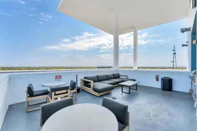 a living room with a couch and a table and chairs at Modern 3 bedroom condo in downtown w free parking in Orlando