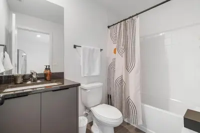a bathroom with a toilet and a sink and a shower at Colorful vibrant Oasis Sleeps 10, 10min to Disney in Kissimmee