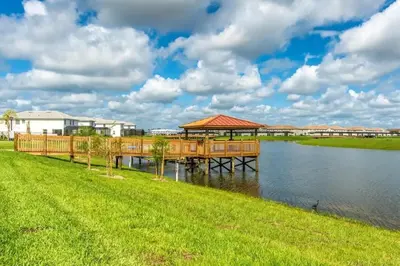 a dock with a gazebo on the water at Casa 4Q com Piscina Privativa Próxima à Disney in Kissimmee