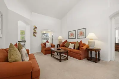 a living room with two couches and two tables at 373 - Stunning 4 Bedroom Villa with own Private South East Facing Pool in Orlando