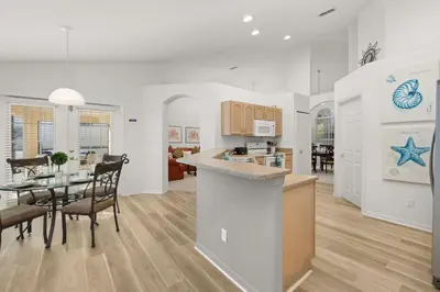 a kitchen and living room with a table and a dining room at 373 - Stunning 4 Bedroom Villa with own Private South East Facing Pool in Orlando